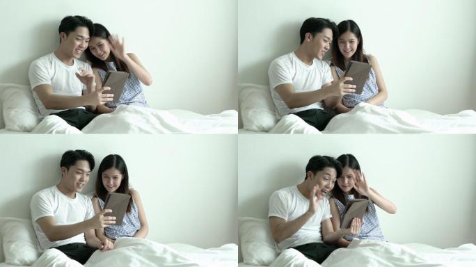 视频通话的夫妇年轻夫妻情侣同居视频通话自