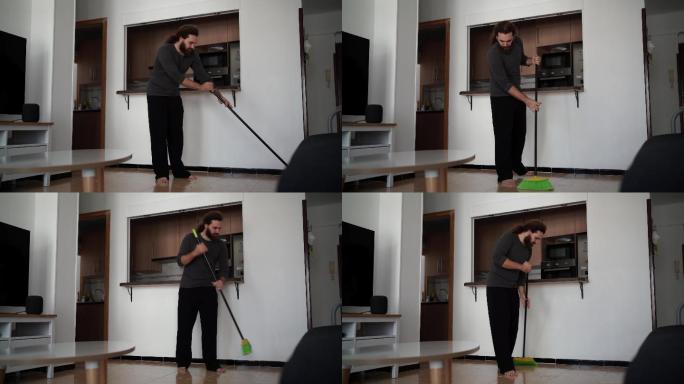 男人用绿色扫帚扫地