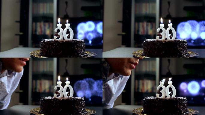 年轻人在他的生日蛋糕上吹蜡烛。