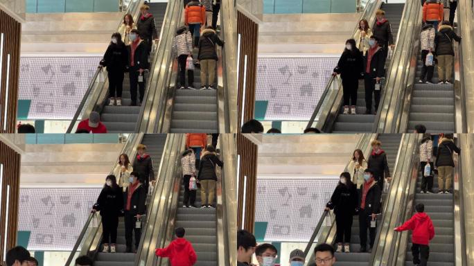 新冠疫情下的商场手扶电梯戴口罩防护的顾客