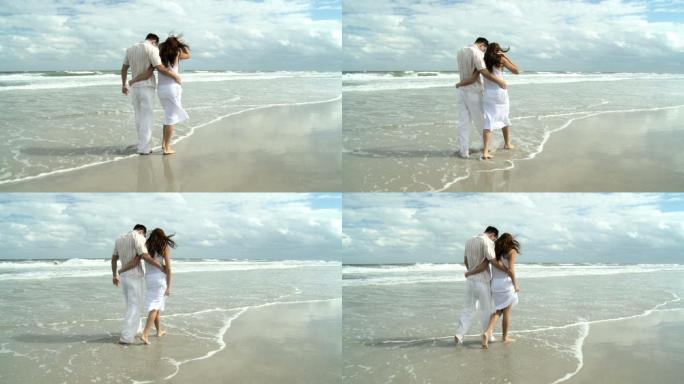海滩上的浪漫情侣婚礼婚庆牵手拥抱幸福生活
