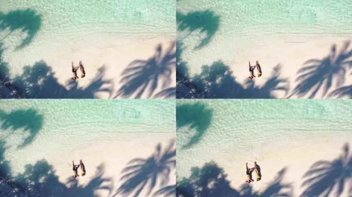 躺在沙滩上的情侣棕榈树椰子树航拍