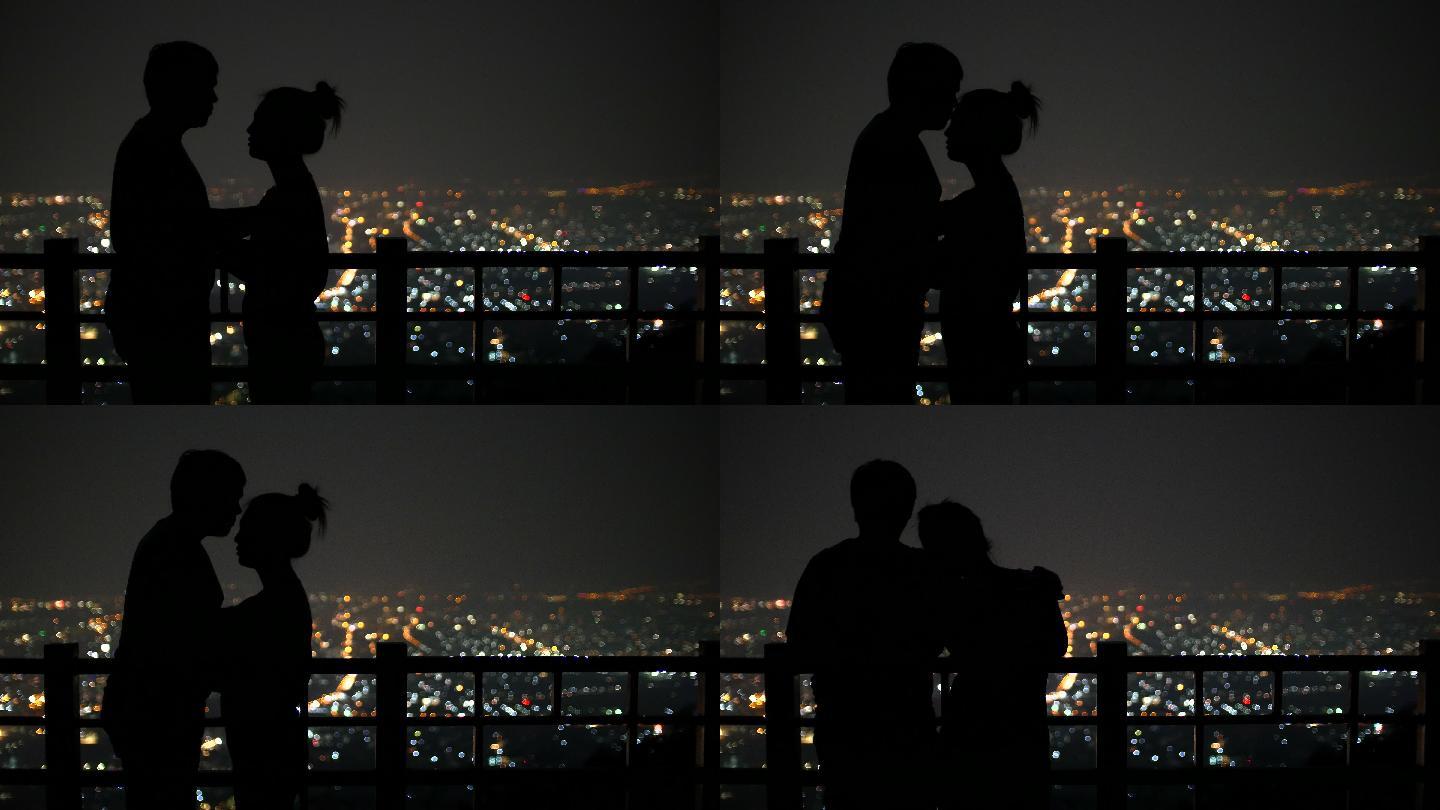 年轻情侣在城市背景下接吻