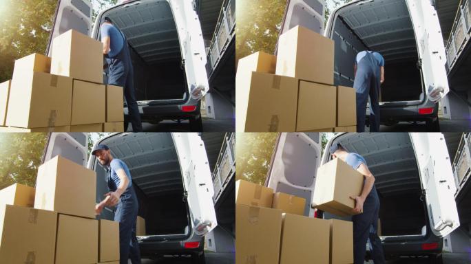 送货员把纸箱装放进他的货车