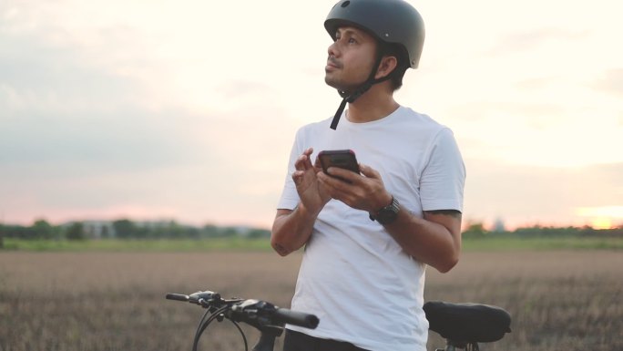 骑自行车的人在户外使用智能手机