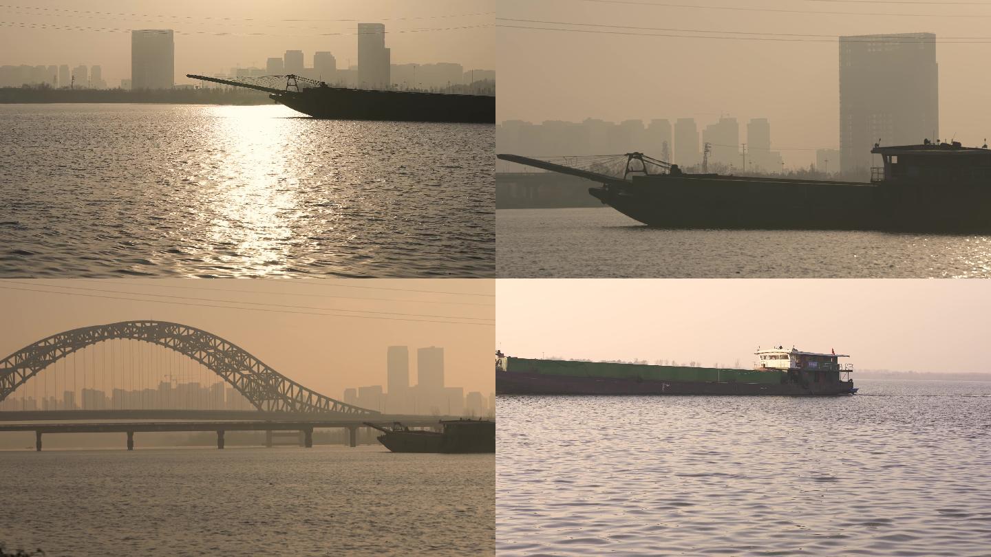 货船行驶长江江面襄阳城区清晨金光逆光唯美