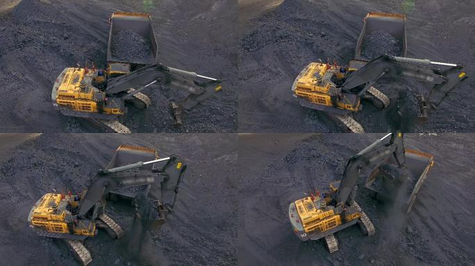 挖掘机把煤装进自卸卡车