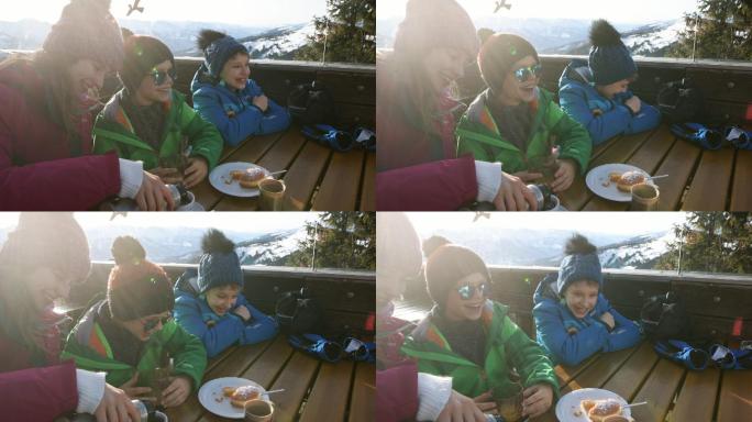 小滑雪者在阿尔卑斯滑雪酒吧吃午餐
