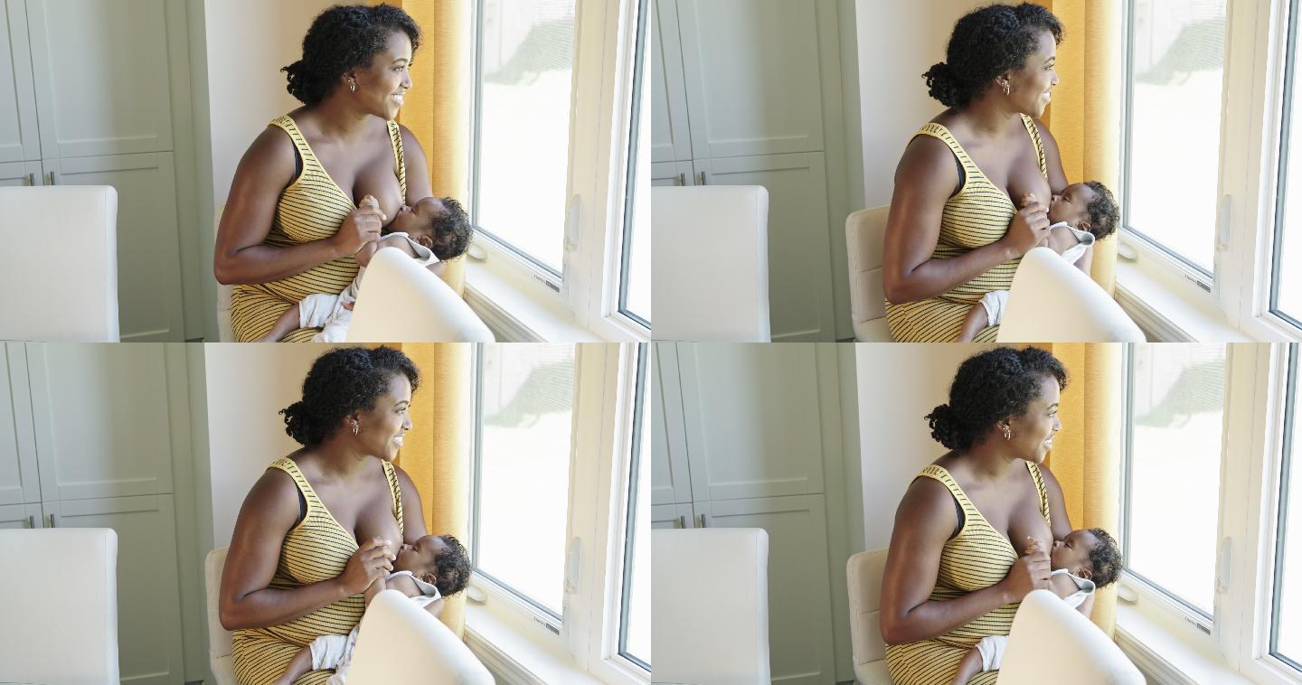 妈妈坐在窗边给婴儿哺乳