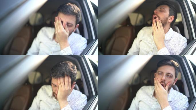 焦虑的司机开车的男子晨光中捂脸抚脸犯困