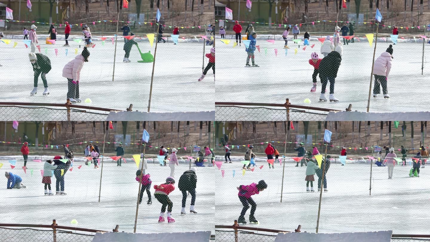 游乐场小孩子们在冰面上滑冰