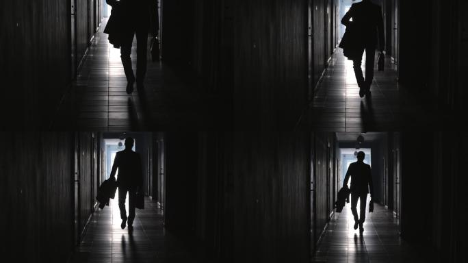 商人沿着黑暗的走廊行走的后视图