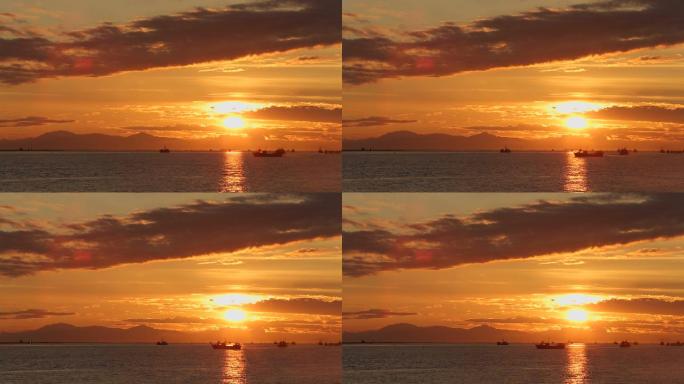 美丽的夕阳黄昏海上渔船出海打渔剪影云层海