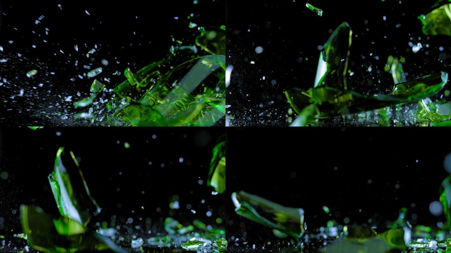 绿色玻璃在黑色表面破碎