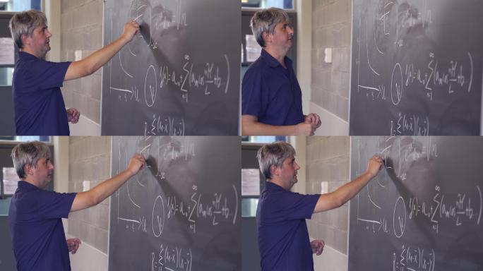 中年数学老师在黑板上写公式