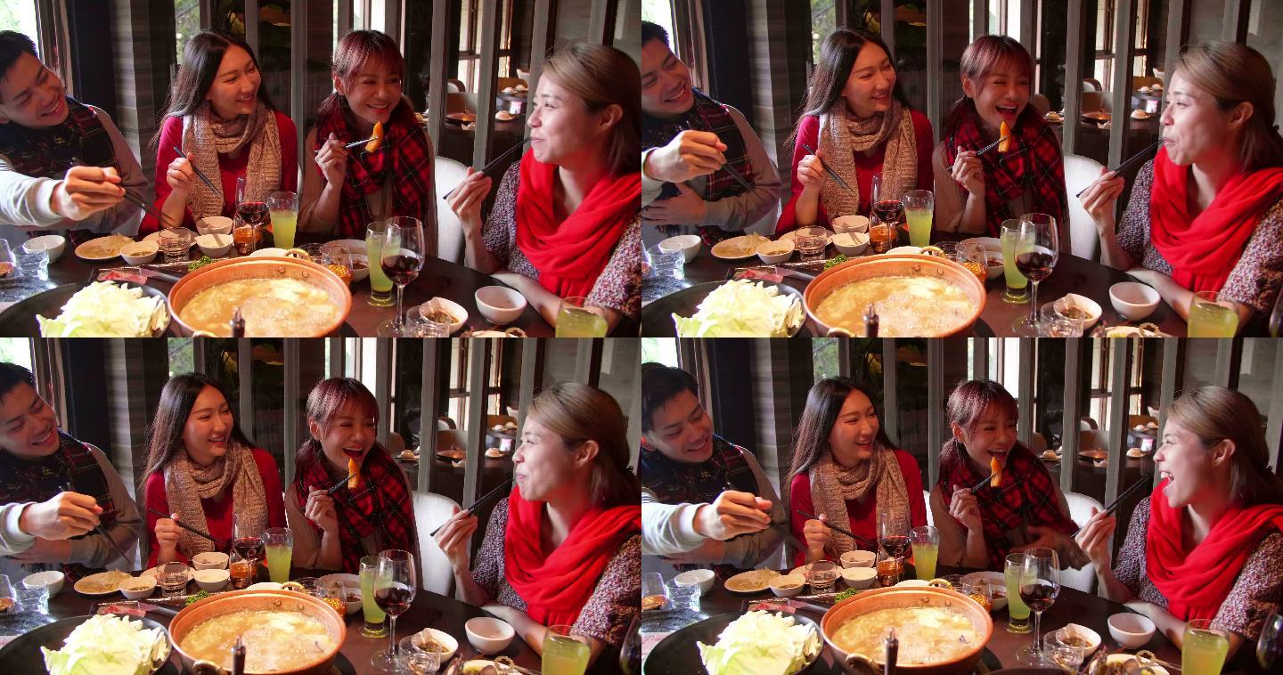 快乐的年轻朋友们在火锅餐厅享用晚餐
