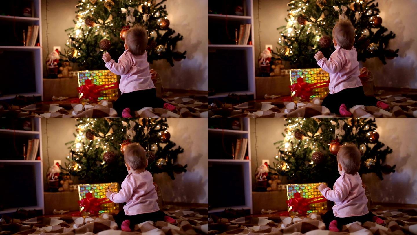 女婴触摸圣诞树的后视视频