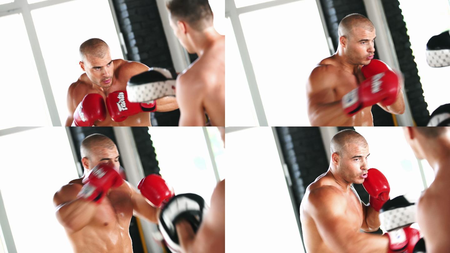 赤膊肌肉男在健身房练习拳击