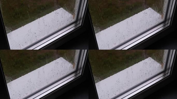 雨滴落在白色的窗台上
