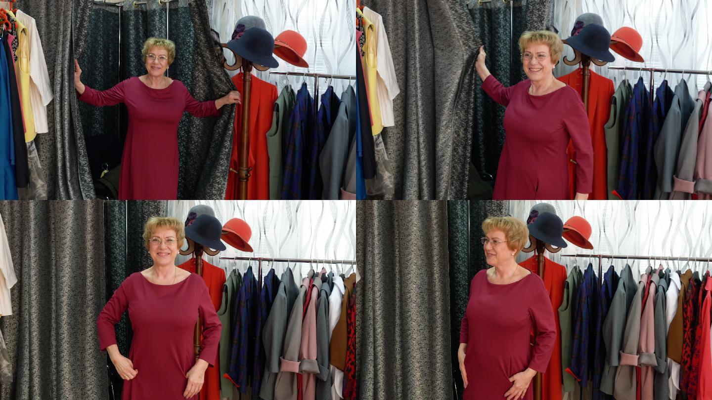 快乐的老妇人在时装店试衣间试穿新衣服