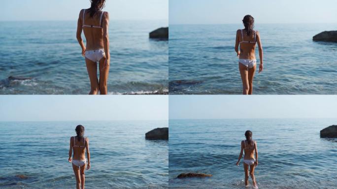 年轻女孩在海上慢镜头穿着比基尼