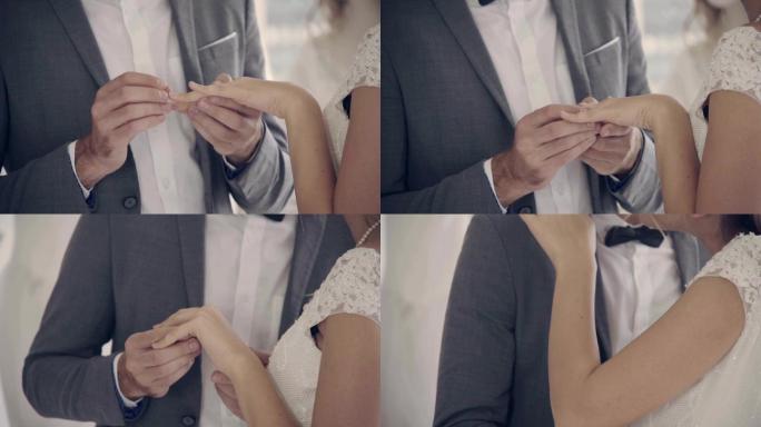 穿着婚纱的新娘和新郎在婚礼上交换戒指