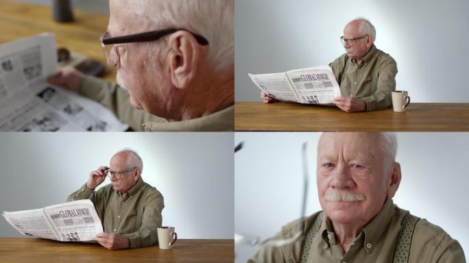 老人早上坐在桌子旁看报纸