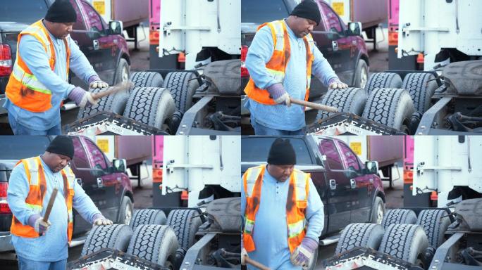 卡车司机检查轮胎气压是否安全