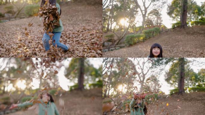 小女孩在公园里玩落叶
