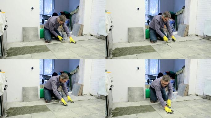 建筑工人修理地板瓷砖。