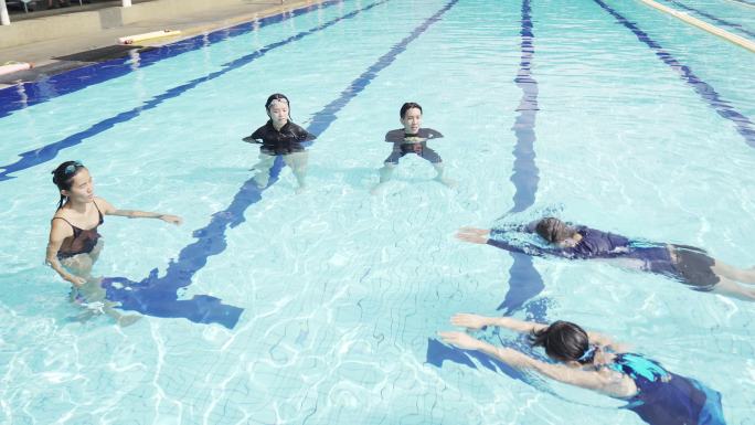 中国游泳运动员在泳池教授游泳技巧