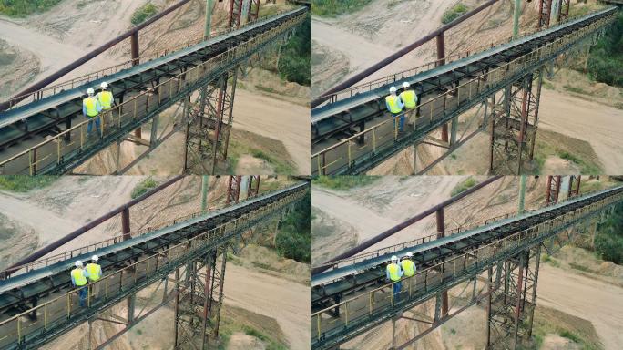 男工程师正沿着港口的栏杆行走