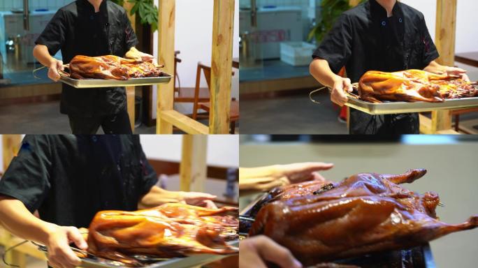 广东烧卤店的师傅端出两只新鲜出炉的烧鸭
