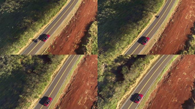 飞过红色敞篷车航拍俯瞰开车行驶农村道路