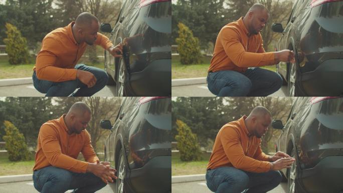 沮丧的非洲男子汽车坏了爆胎男人面对汽车叹