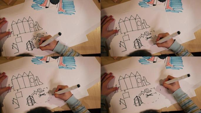 小男孩在纸上画太空火箭