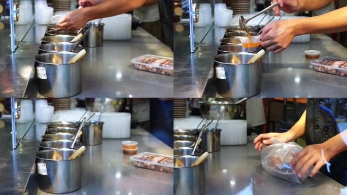 广东烧卤店里店员正在打包豉油鸡，装酱汁