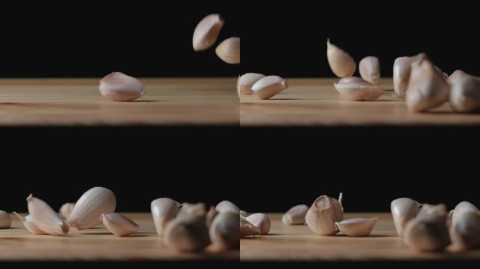大蒜种子掉入木桌的慢镜头