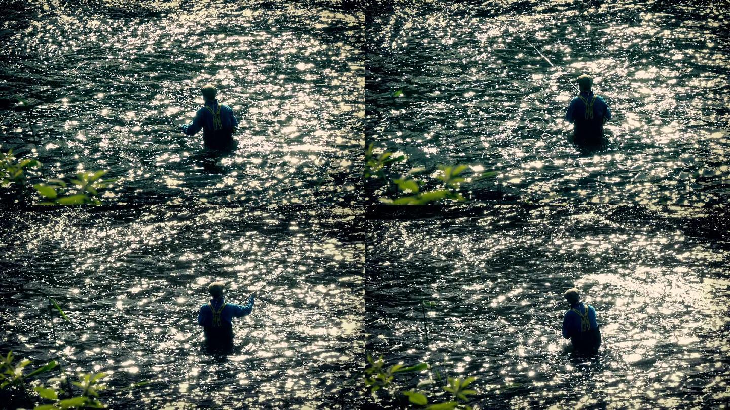 男人在齐腰深的水中钓鱼