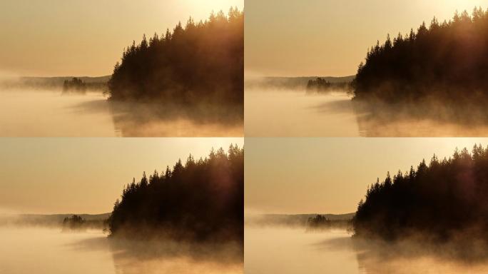 日出时湖面上的晨雾
