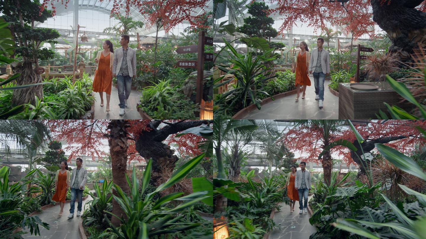 情侣在温室植物园游览
