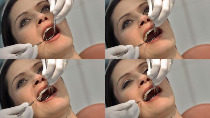 牙医检查年轻女性患者牙齿