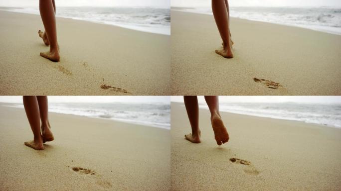 沙滩上步行的人脚步特写海边印记青春足迹