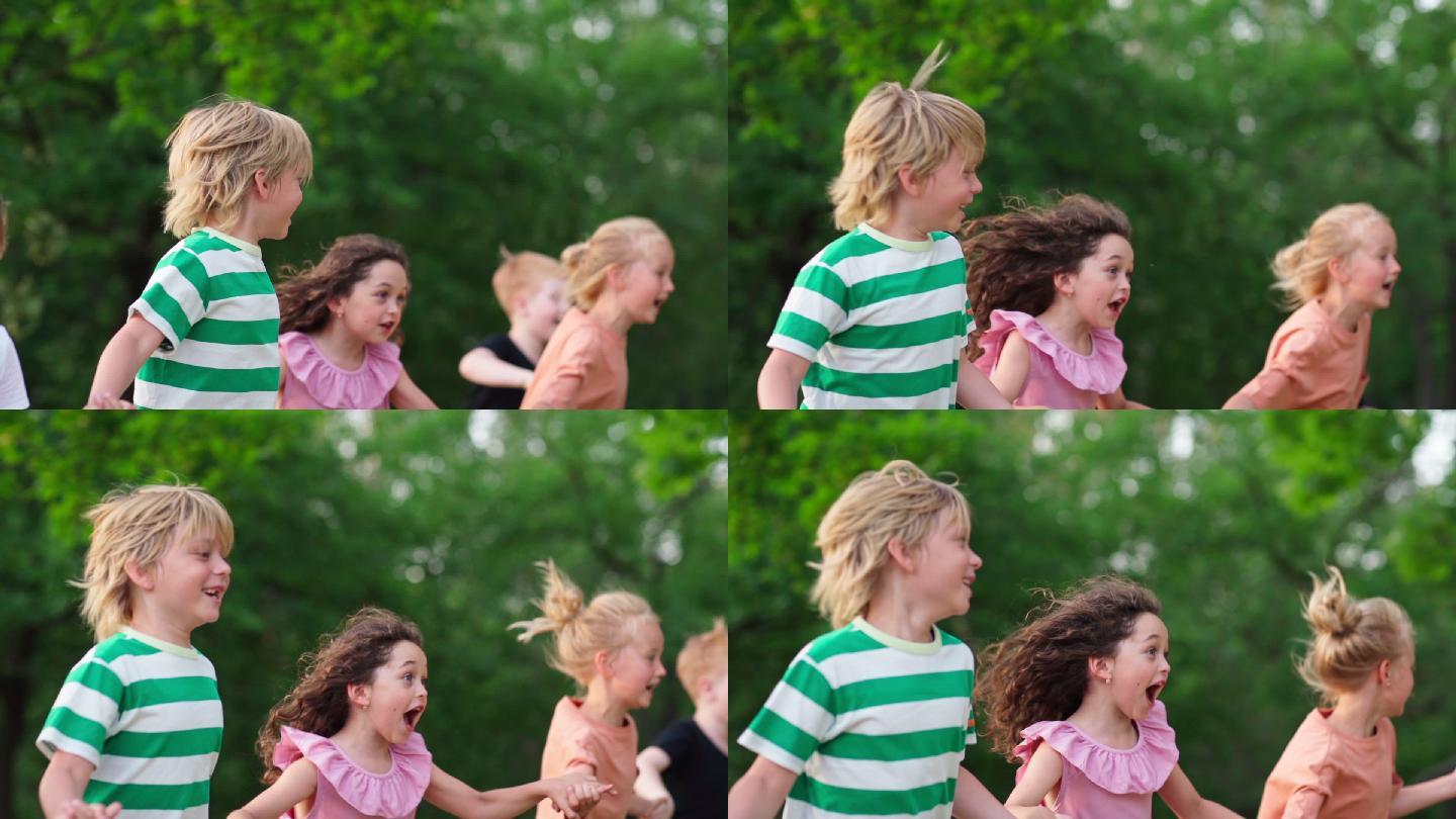 一群快乐的孩子在绿色公园的户外跑步