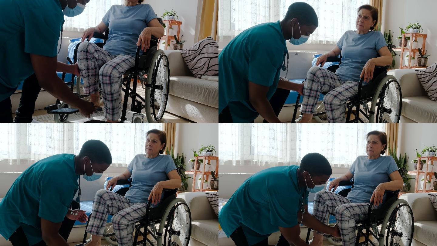 男护士在养老院轮椅上帮助老年人