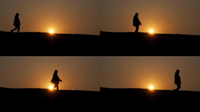 女孩剪影行走在夕阳下