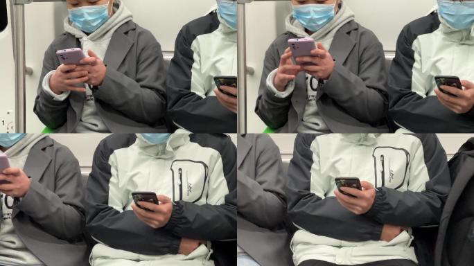 新冠疫情低头族戴口罩坐地铁沉醉式玩手机