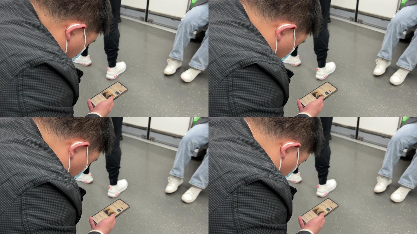 乘坐地铁沉浸式看手机的男人
