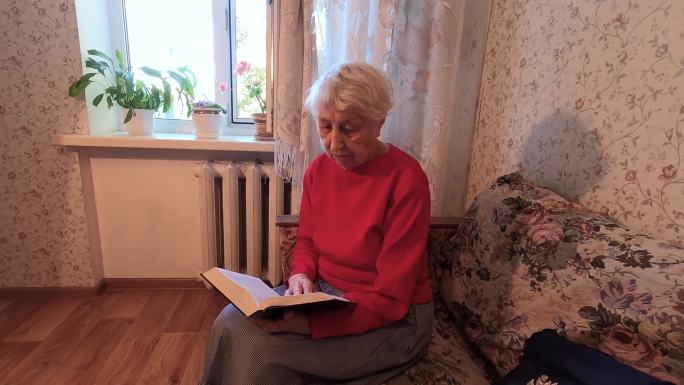 老妇人在家看书老人翻页休息