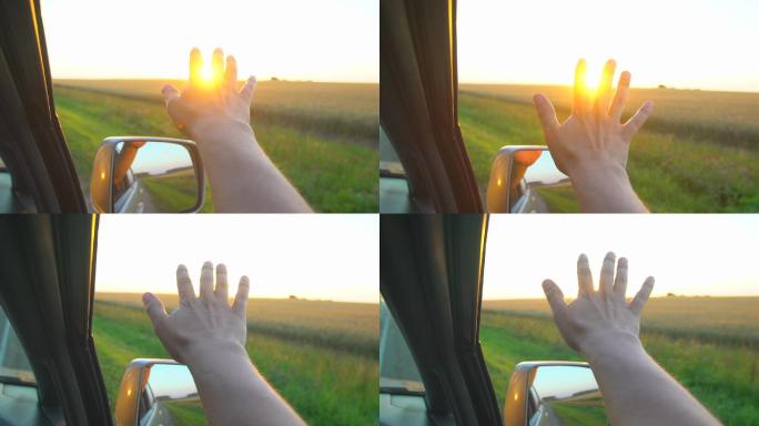 日落时一个人的手从车窗伸出